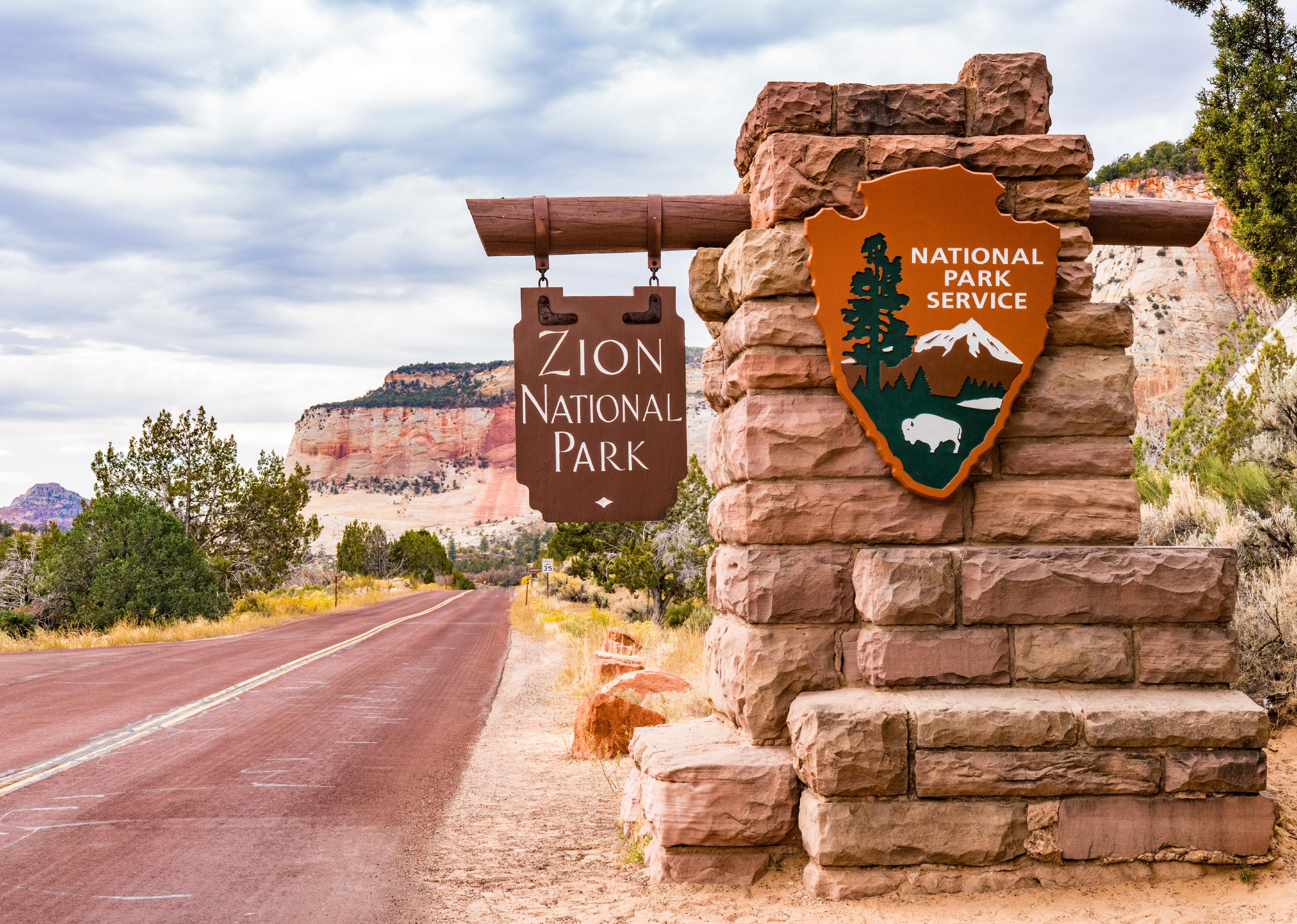 Entrance sign to Zion National Park in Springdale, Utah.