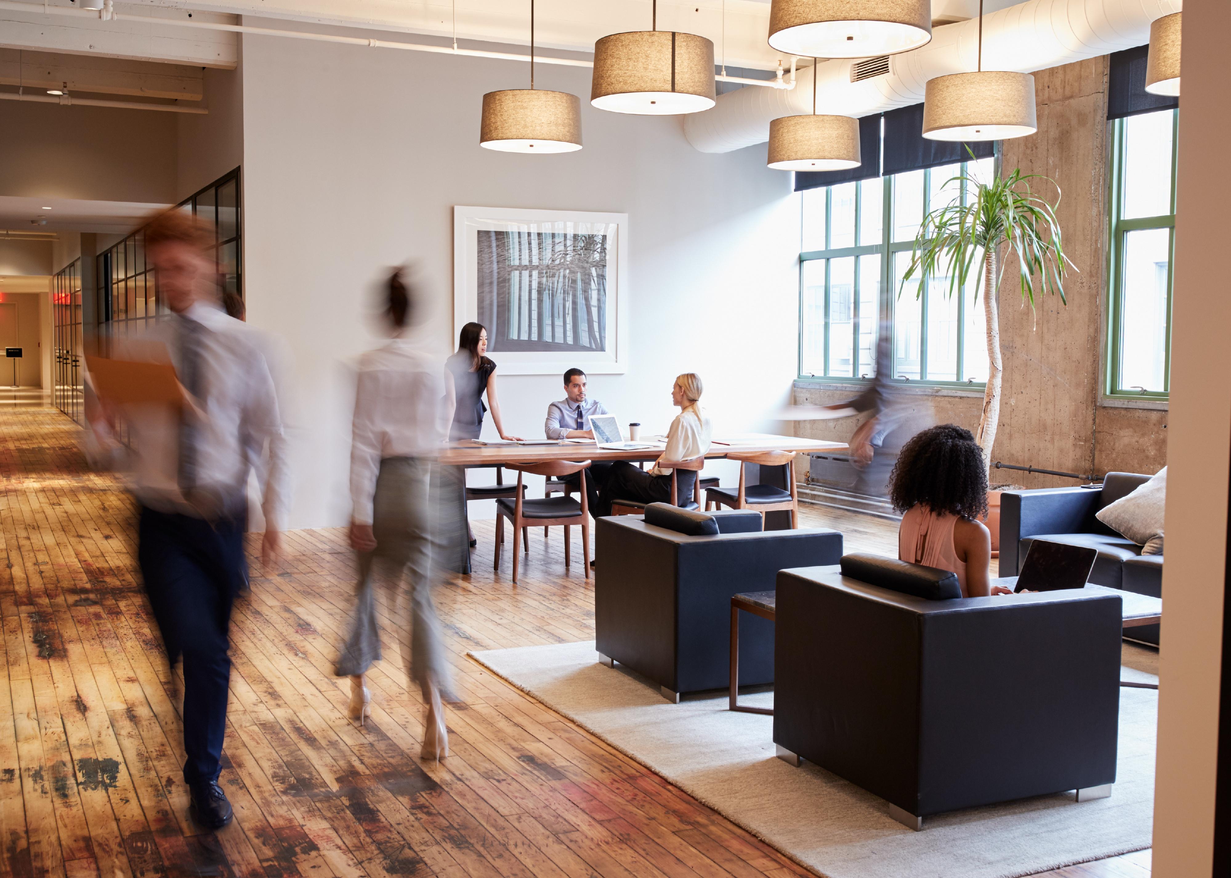 Businesspeople at work in a busy office space.