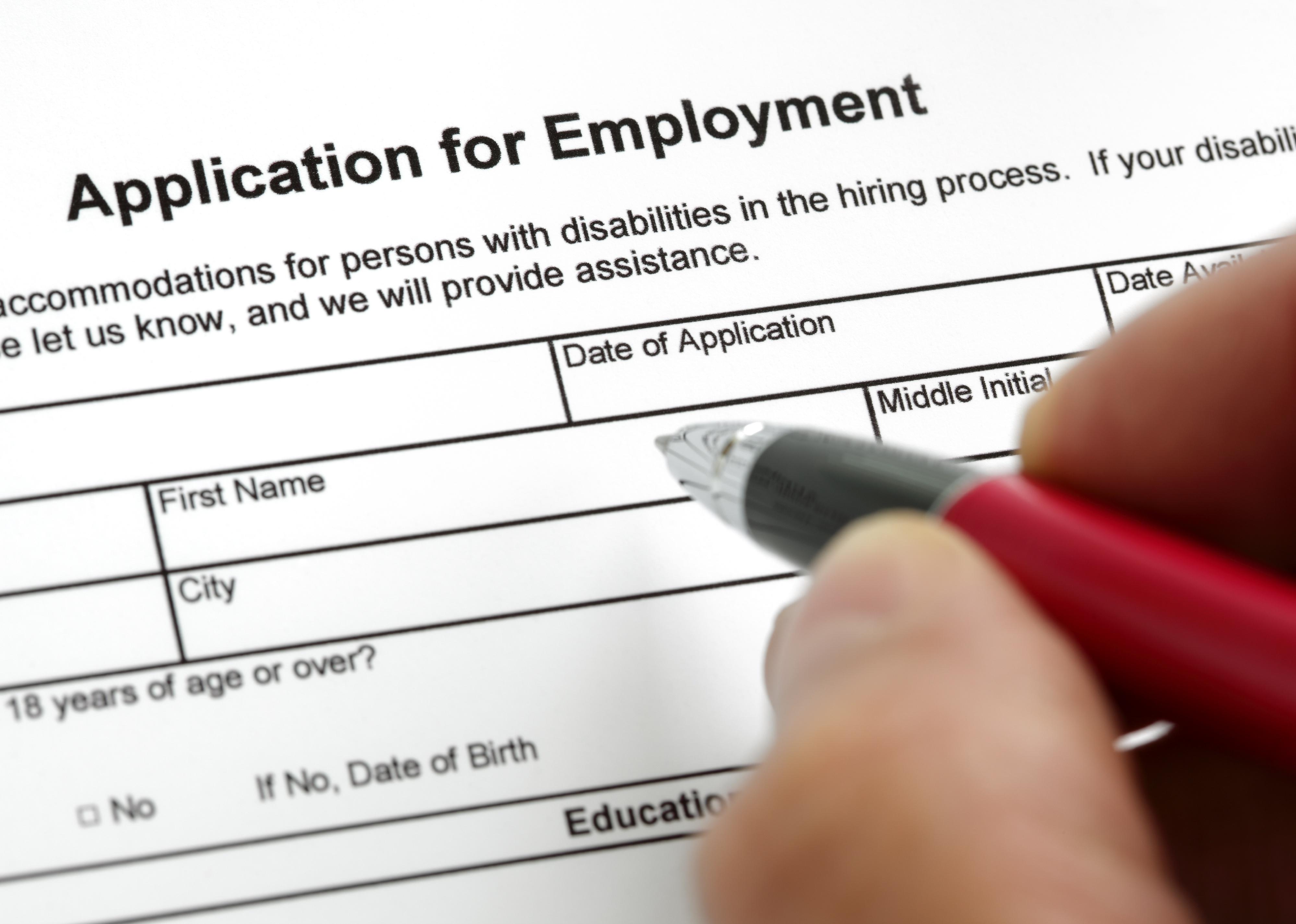 Person completing a job application form.