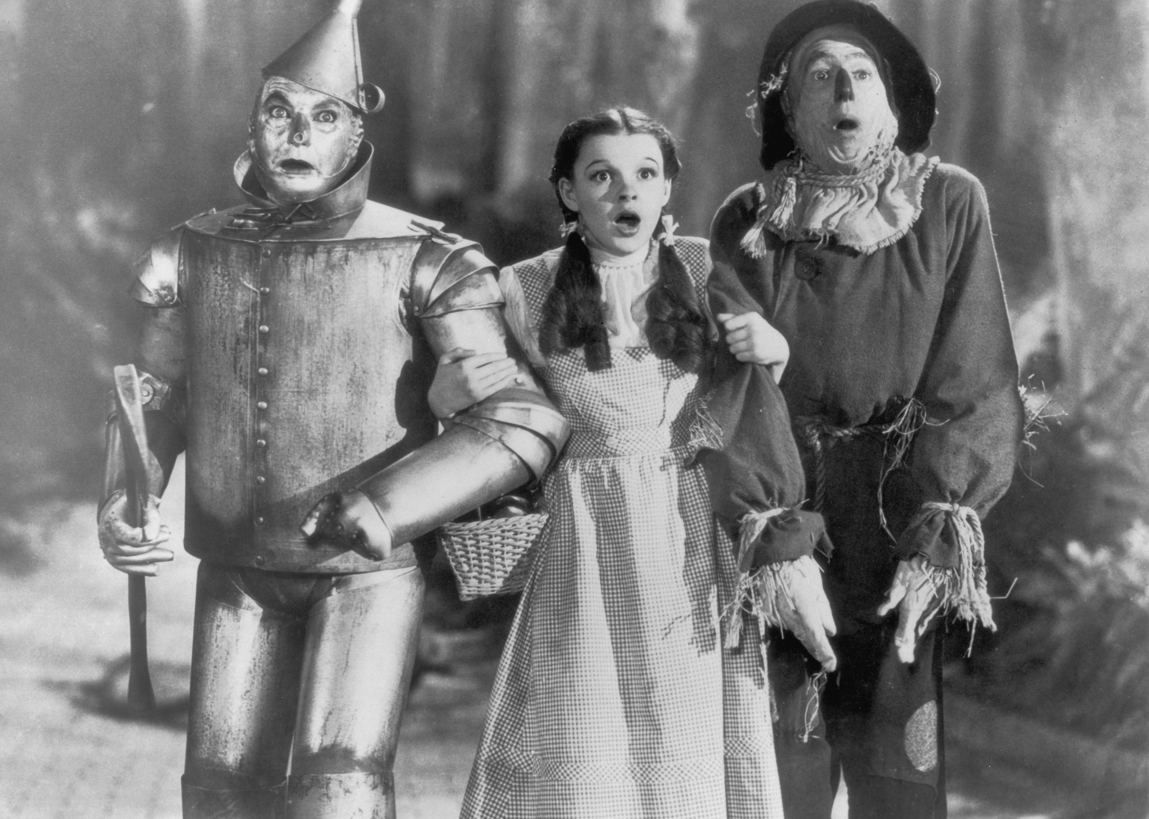 Judy Garland with the Tinman and Scarecrow in The Wizard of Oz.