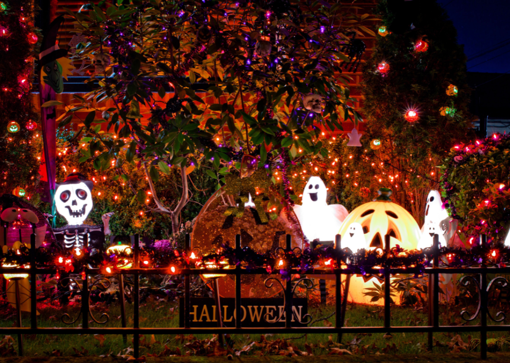 Halloween decorations and lights in a front yard.