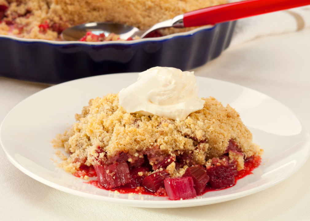 A rhubarb crisp on a white plate.