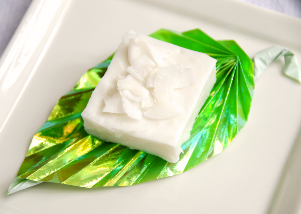 Haupia on a plate with a green decorative leaf.