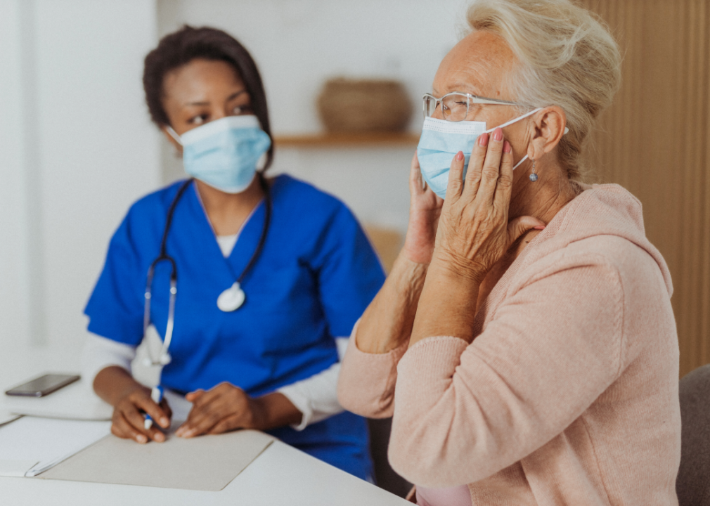 An elderly woman wearing a mask at a doctor