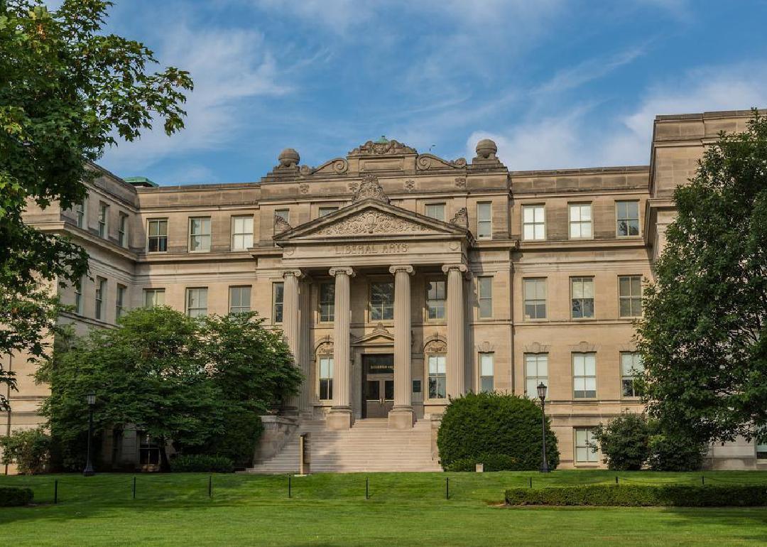 A large greek style stone building with columns.