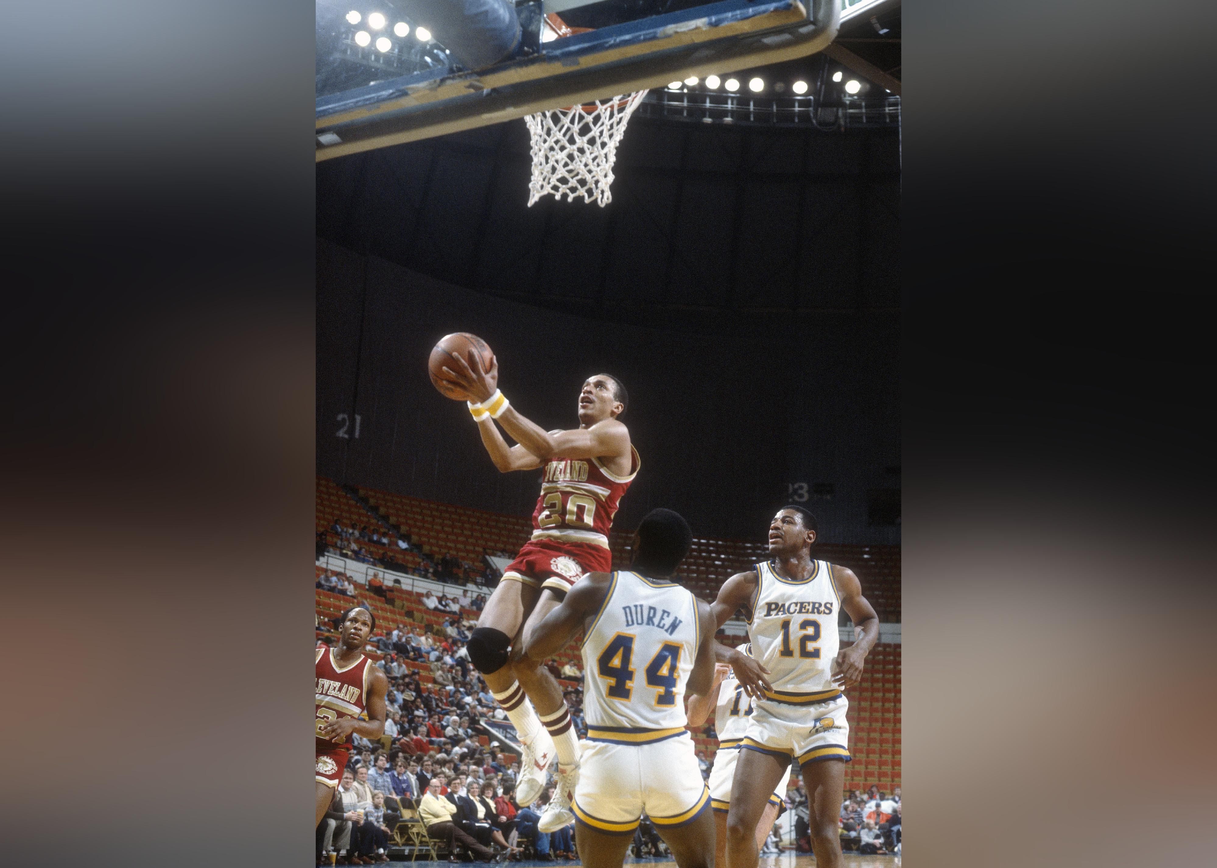 Geoff Huston of the Cleveland Cavaliers goes up to shoots over John Duren of the Indiana Pacers.