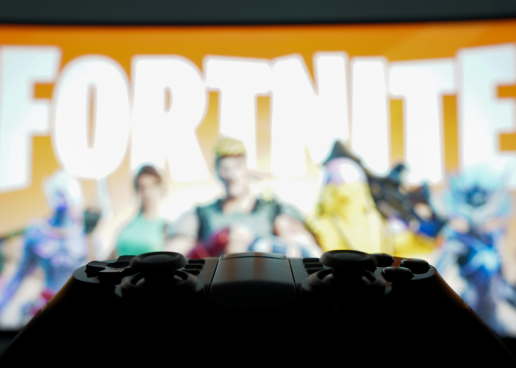 A game controller and Fortnite in the background.