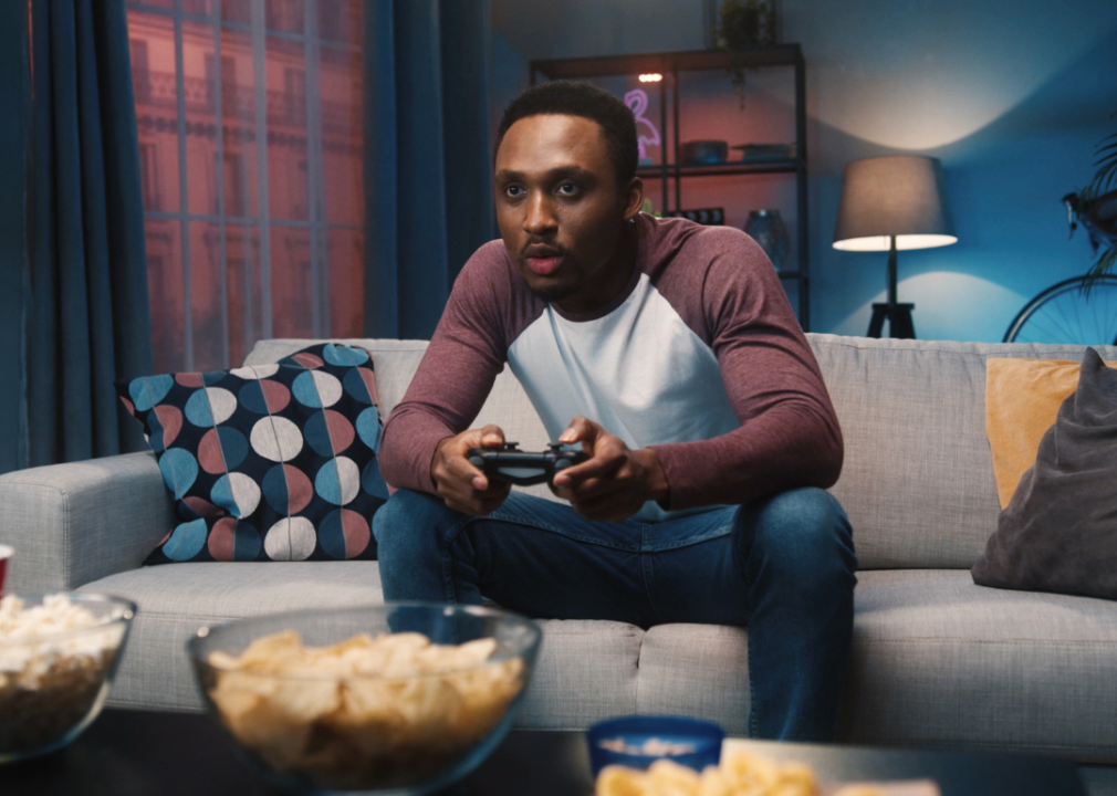 A man sitting on a couch playing video games.
