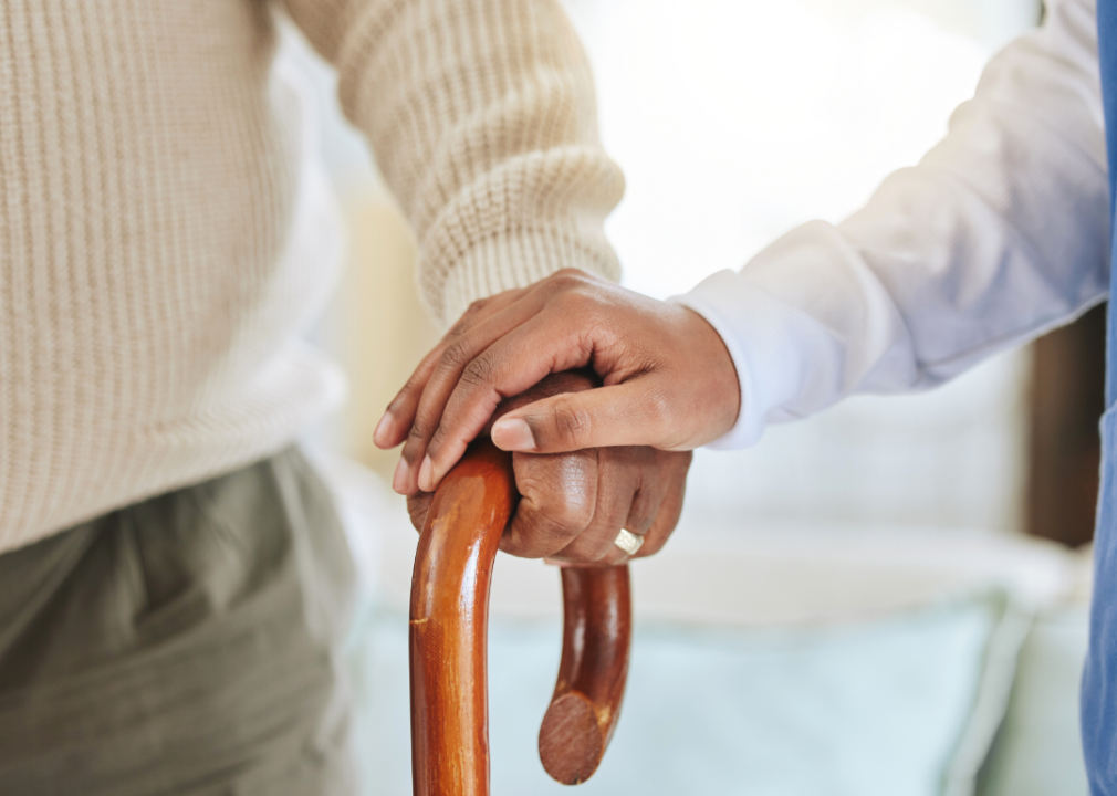 A nurse holding an elderly man