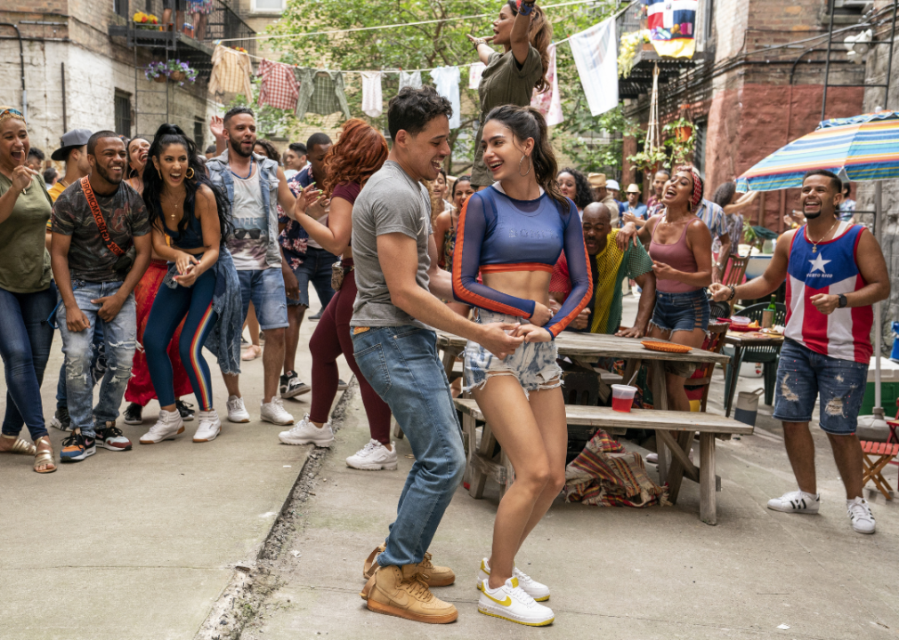 A young couple dancing in a crowd.