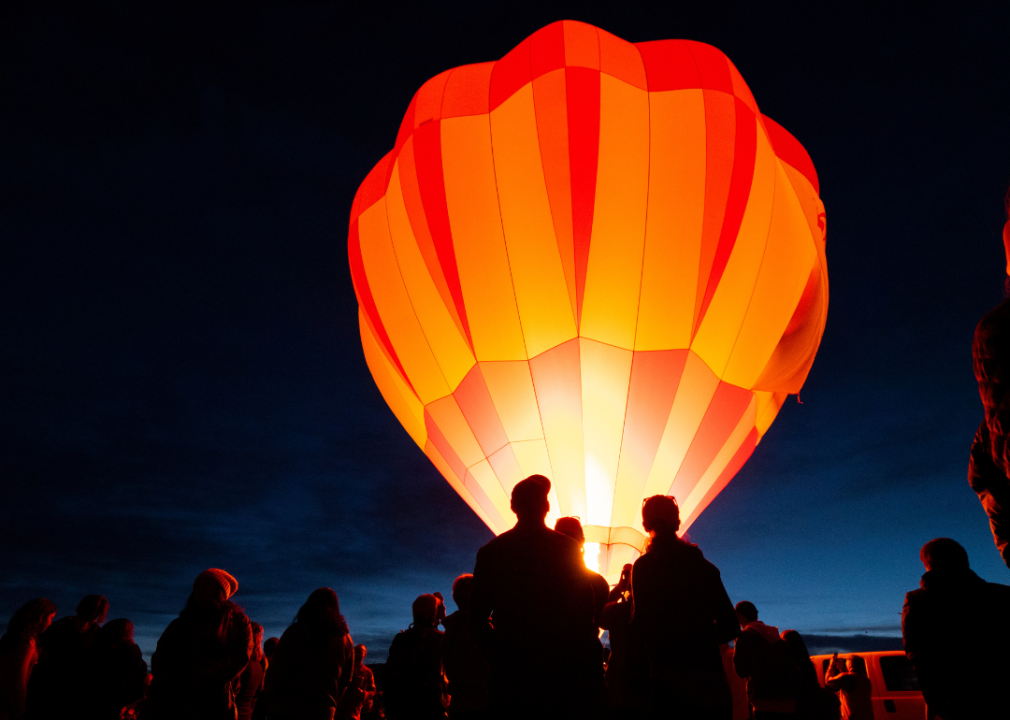 A hot air balloon glowing at night.