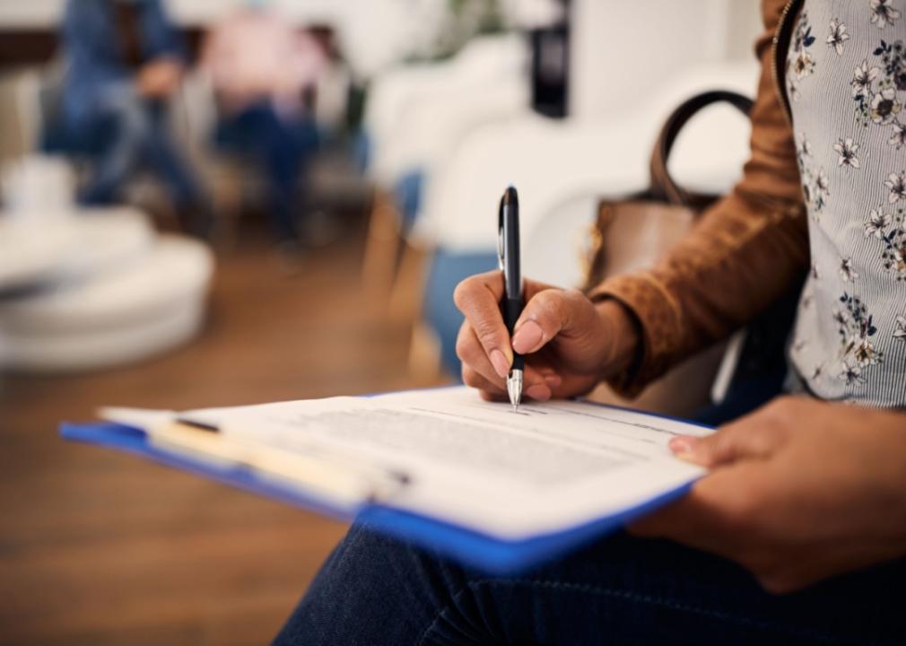A person filling out a medical form.