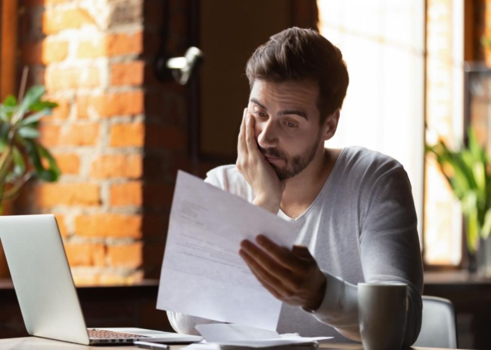 A frustrated man reading a note.