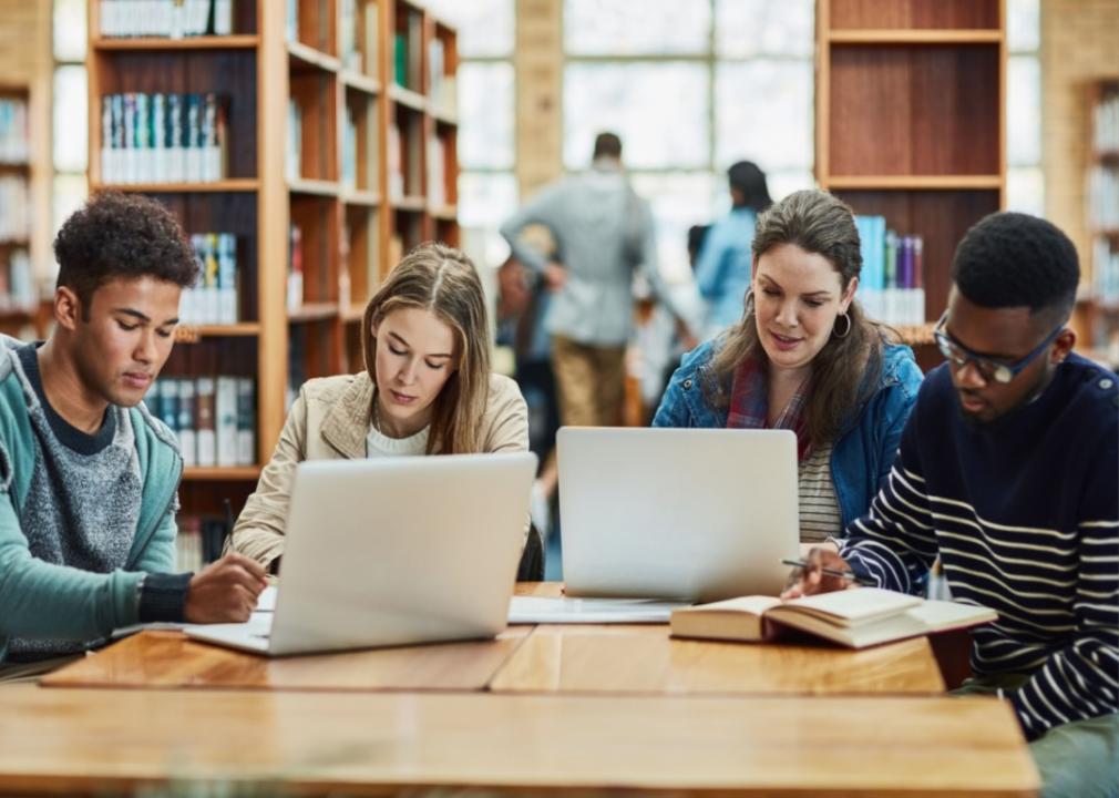 #46. Manhattan University Students working in a library.