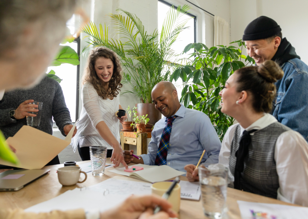 People laughing in a meeting.