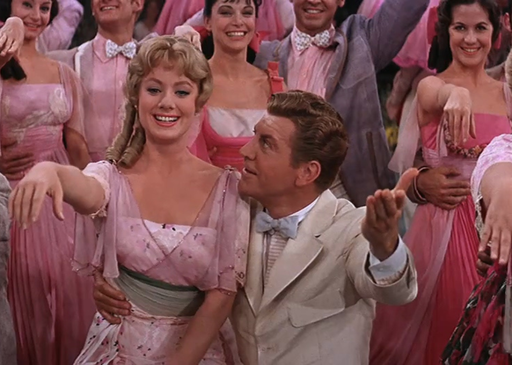 Women in pink dresses dancing with men in suits.