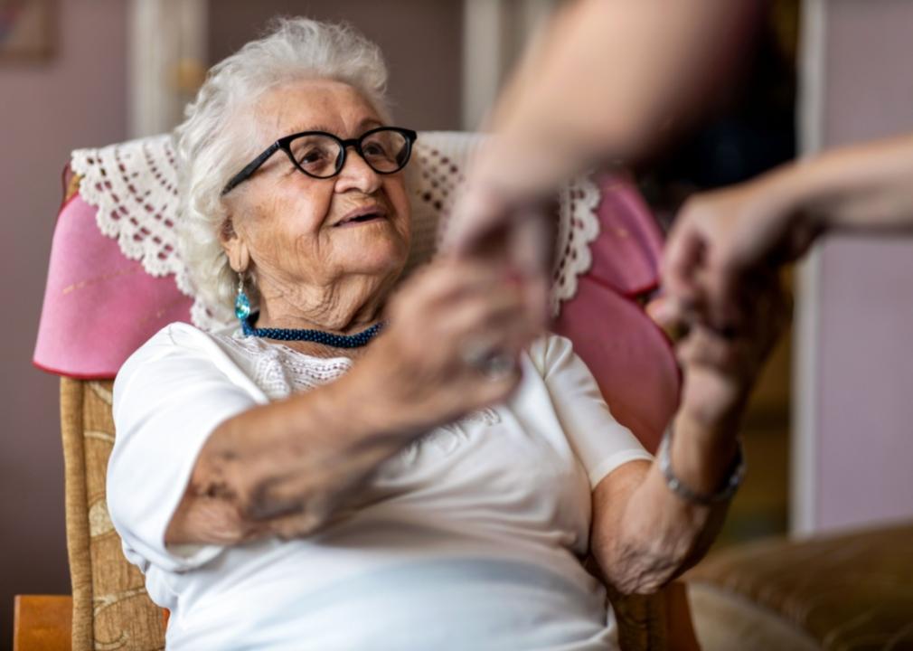 An elderly woman in a chair.