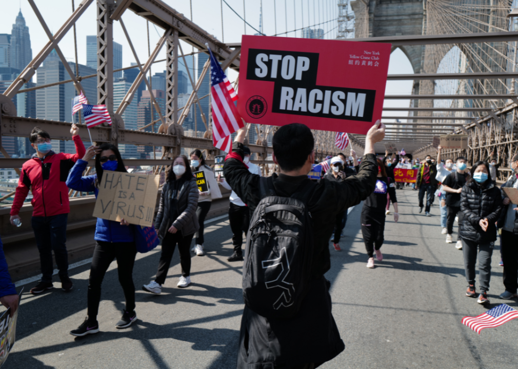 Demonstrators march across Brooklyn Bridge at Stop Asian Hate rally