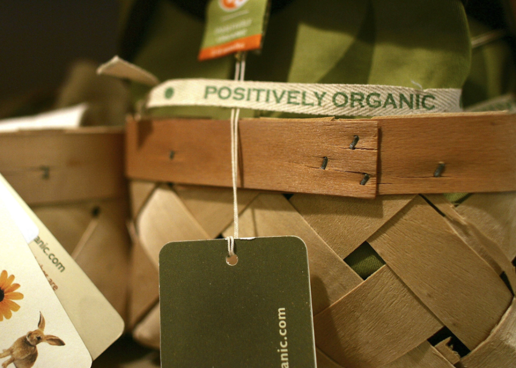 A basket filled with fabric with a label that says positively organic.