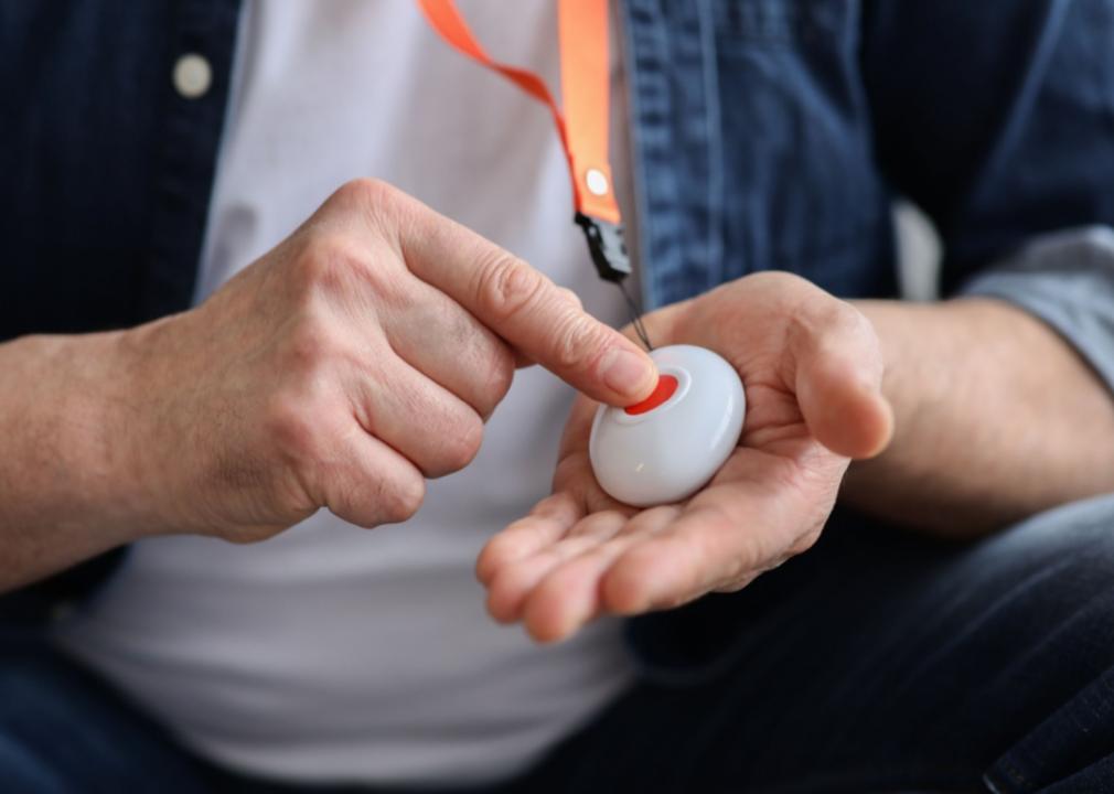 A man pushing a red button.