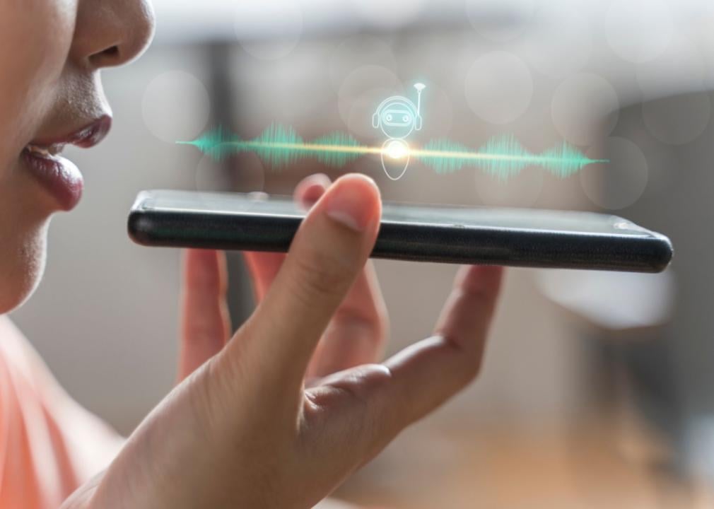 A woman talking into a smartphone.