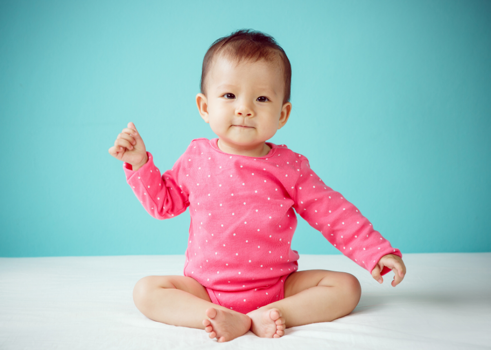 Baby girl wearing pink clothing.