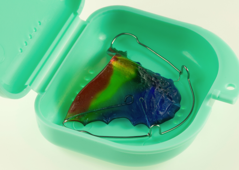 A colorful retainer in a green case.