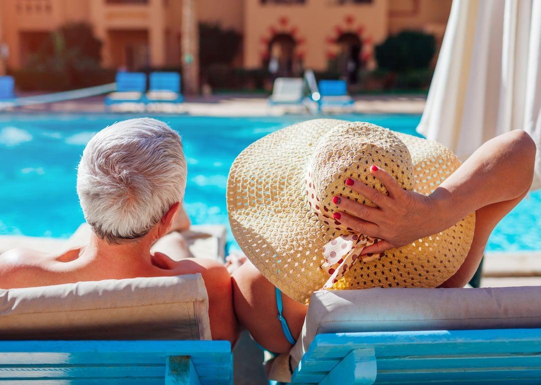 Retired couple by a pool
