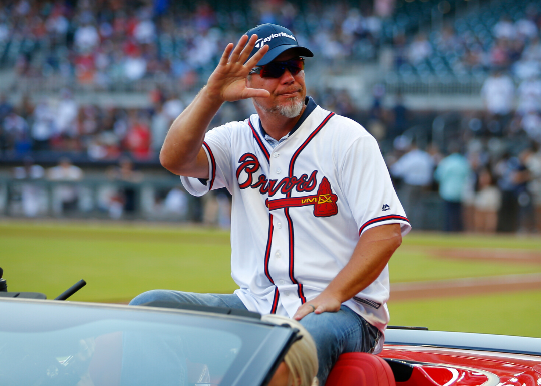 Chipper Jones sits in a car and waves to the crowd in Atlanta.