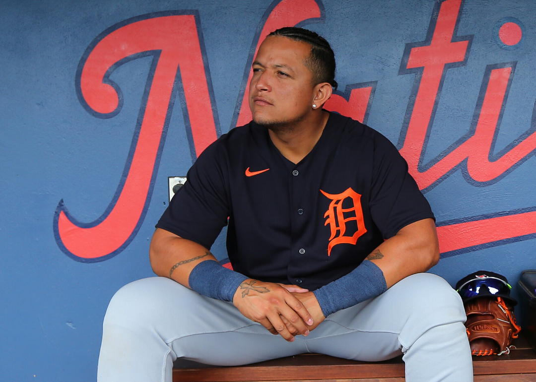 Miguel Cabrera sits in the dugout wearing his Tigers uniform.