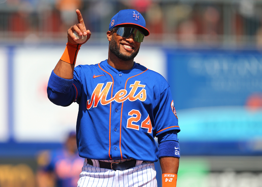 Robinson Canó smiles on the field in a Mets uniform.