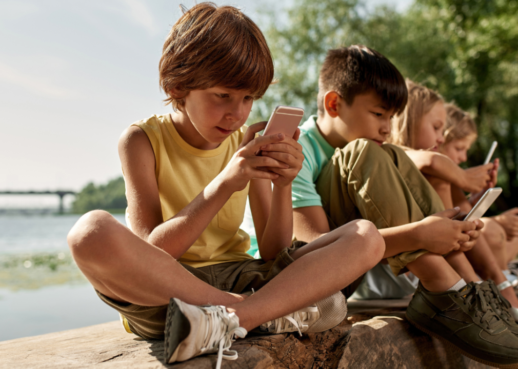 A row of kids on phones.