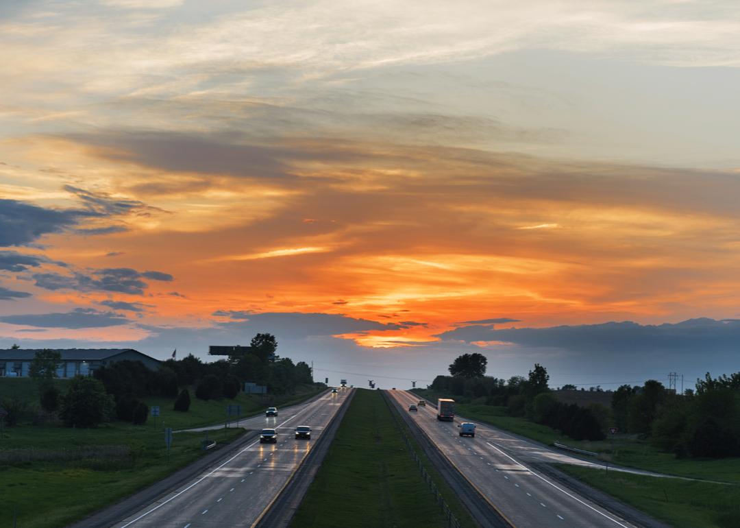 The sun setting over the horizon with I-80 winding its way through the landscape.