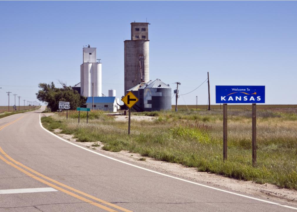 A curving highway near grain elevators in Saunders, Kansas