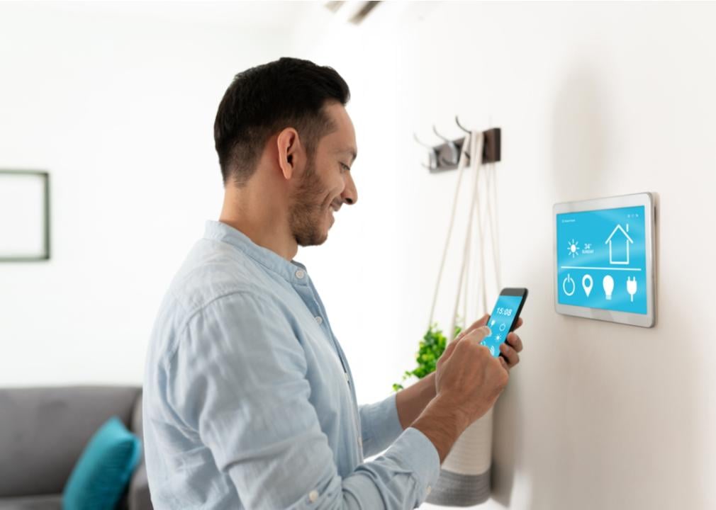 A man setting up his smart home devices with his smartphone