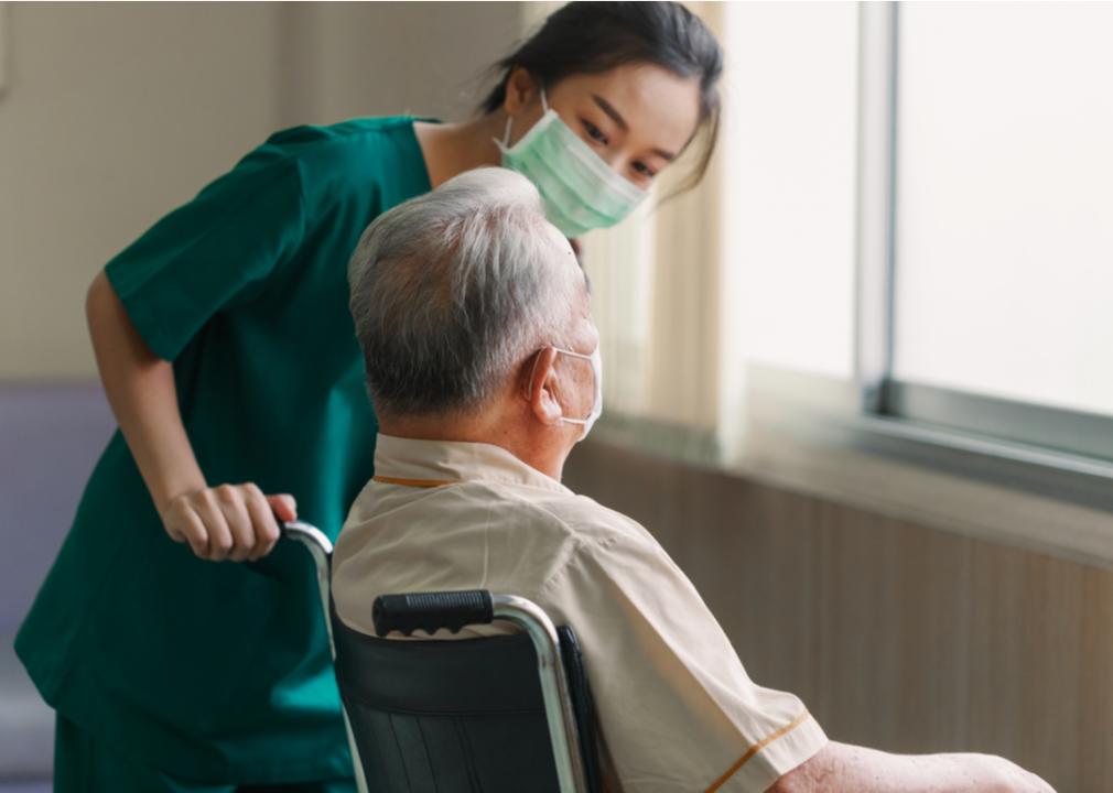 A nurse explaining information to an elderly patient in a wheelchair