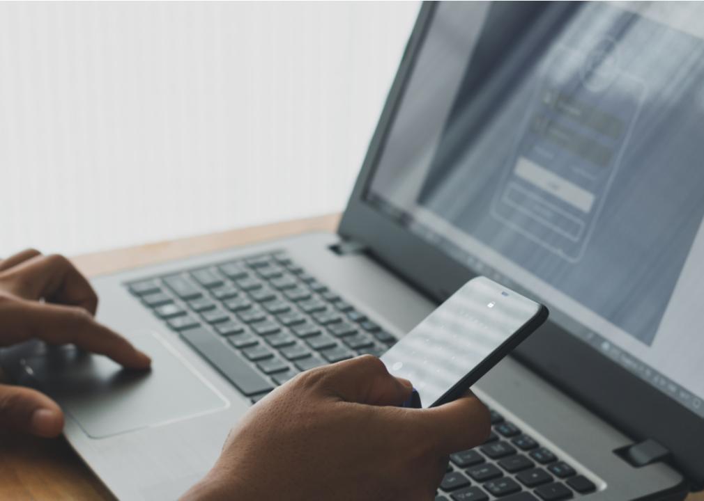 A man using multifactor verification by entering a code sent to his cellphone