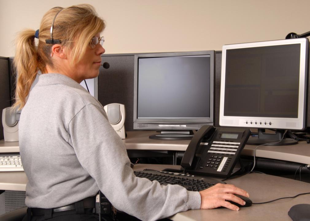 A police dispatcher working at console