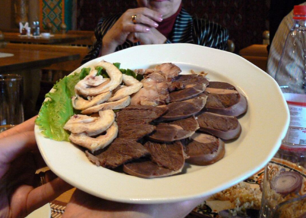 A large dish of prepared horse meat.