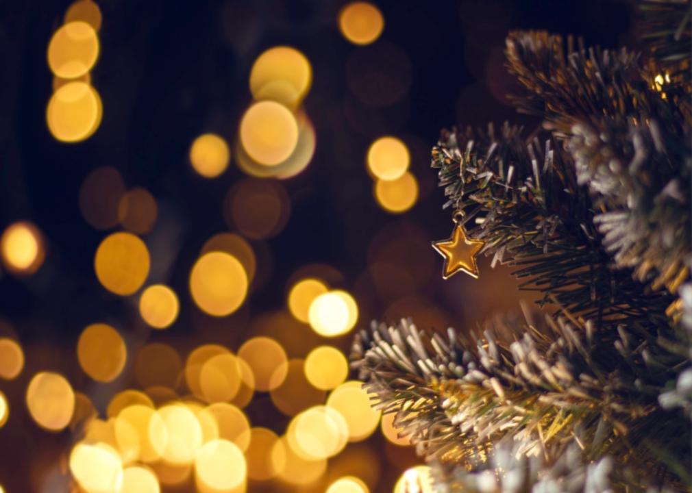 A Christmas tree with golden lights and stars.