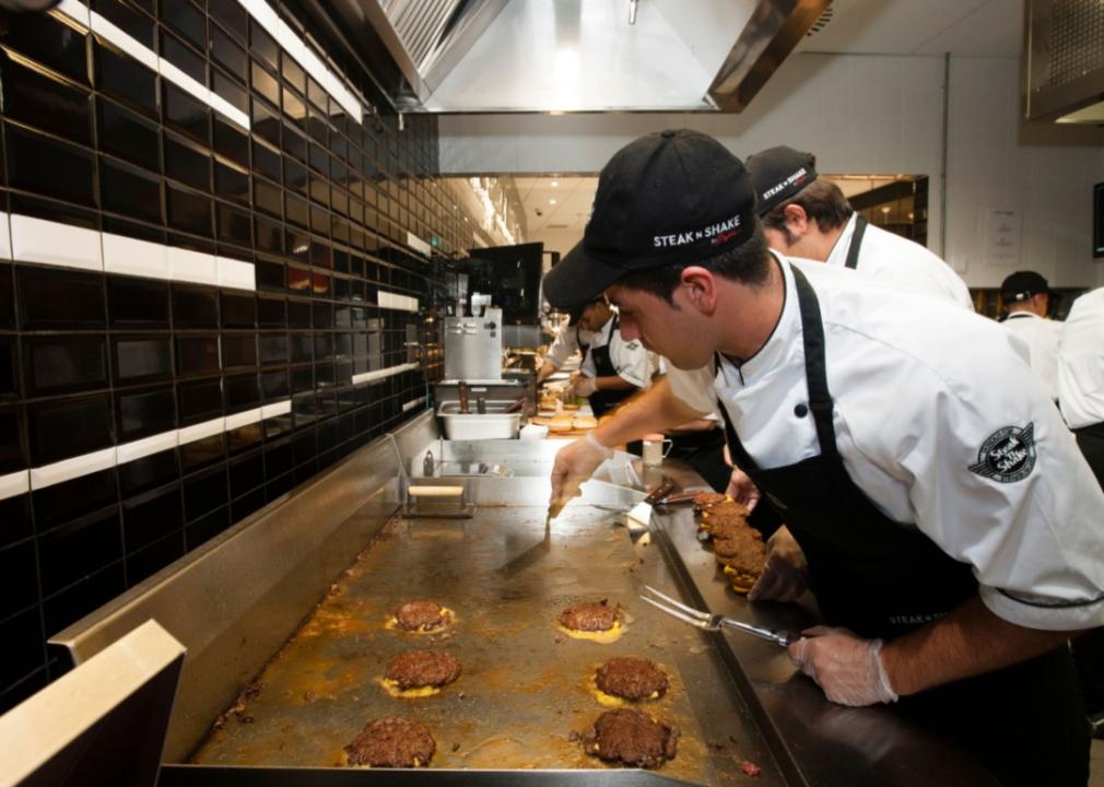 Cooks grilling burgers at Steak 'n Shake.