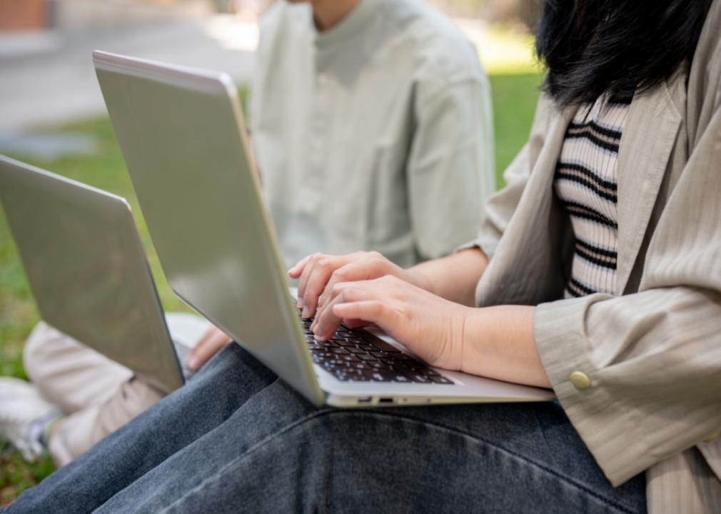 Students typing on laptops.