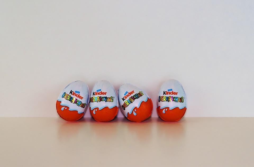 A row of Kinder Eggs resting against a wall.