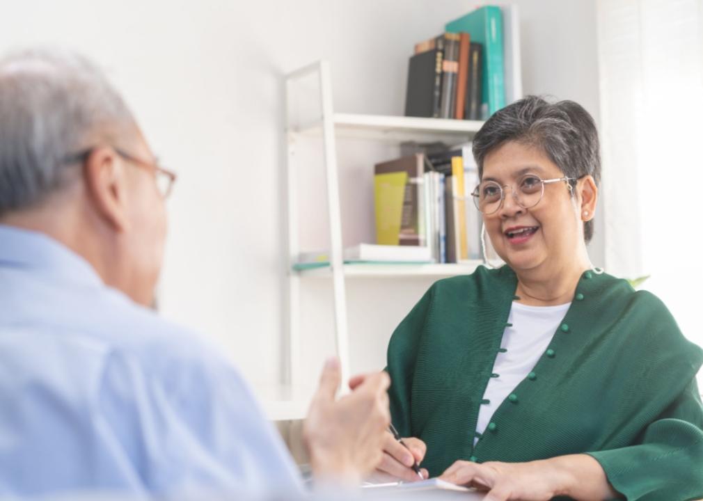 A therapist talking with a patient in an office.