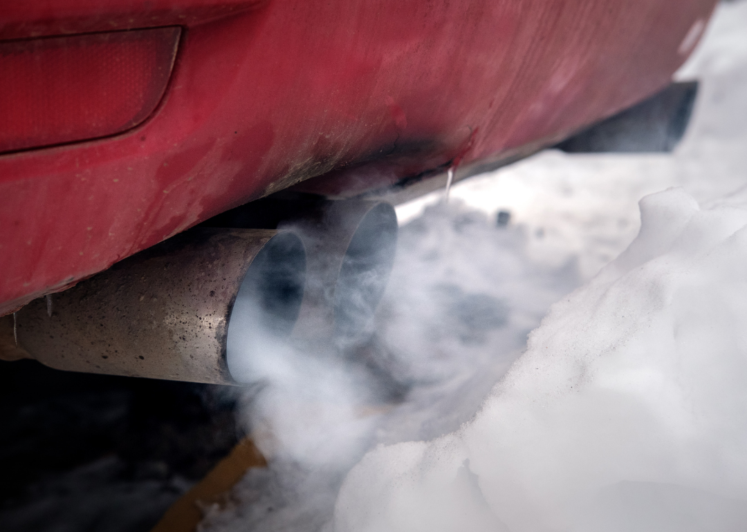 A car's tailpipe emits thick exhaust.