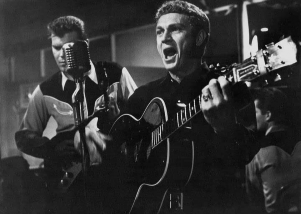 A still of McQueen and Glen Campbell performing in Baby The Rain Must Fall.