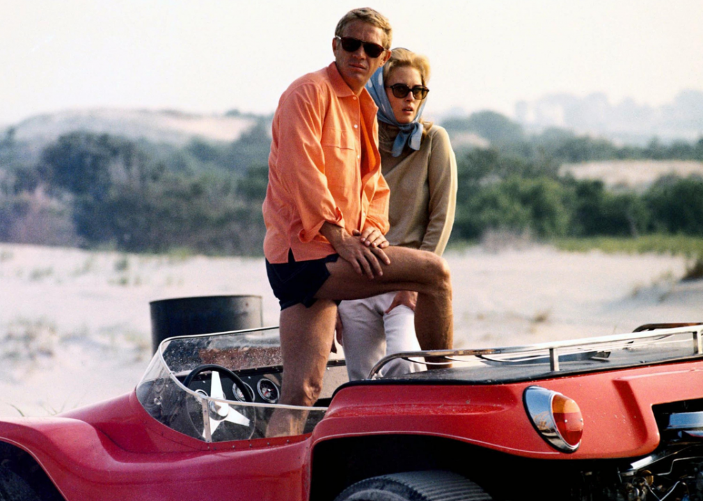 McQueen and Faye Dunaway posing in an open-top car in a publicity image issued for The Thomas Crown Affair in 1968.