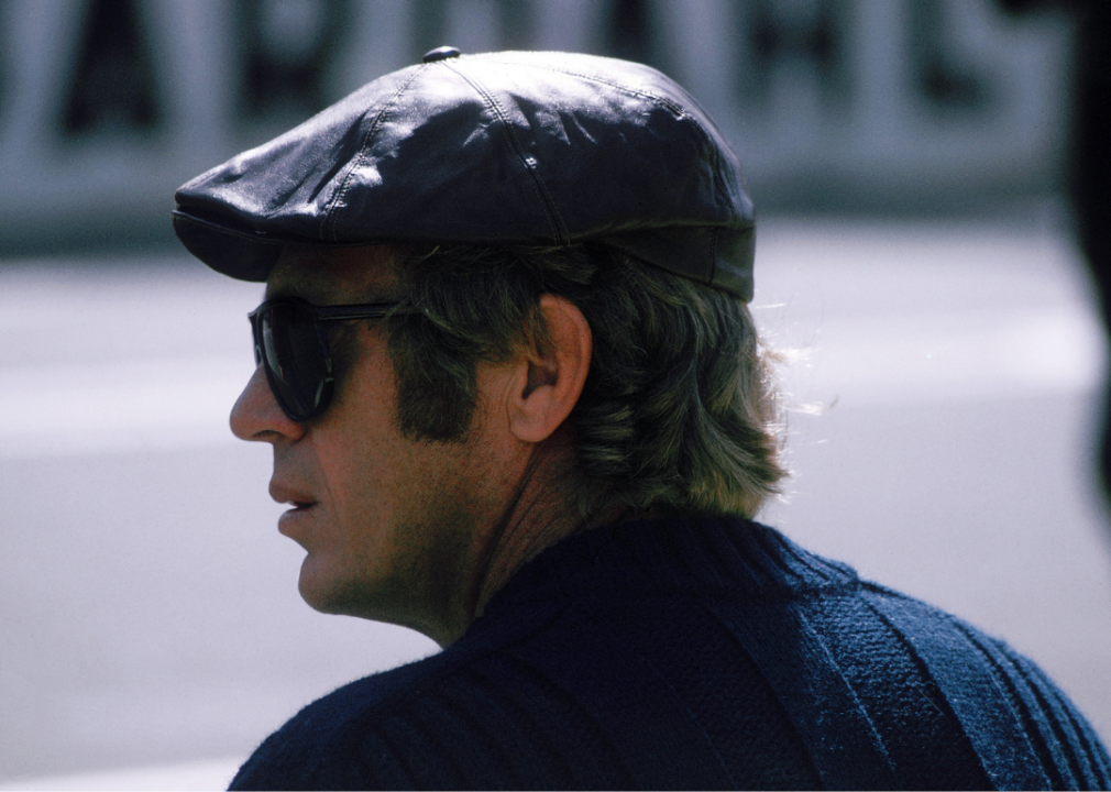 McQueen on the set for Le Mans, wearing a newsboy cap and aviators. 