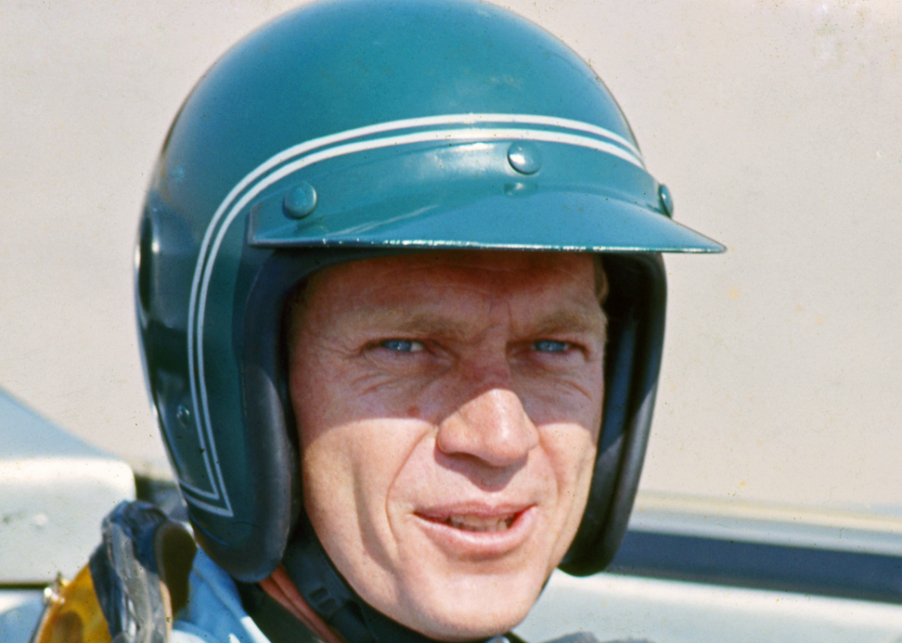 McQueen in a racing suit, sitting in a Lola T70 SL70/14 car, at Riverside Raceway, circa 1966. 