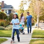 Family walking on suburban street.